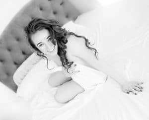 All Smiles in Classic White Sheets Boudoir Photography in Austin, Texas